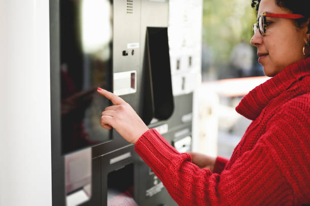 istock Automatic car parking pay station. woman in a red sweater using parking ticket machine in the city 1433544377
