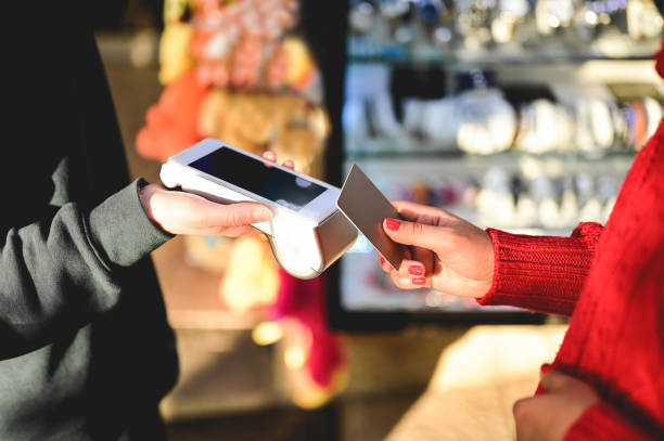 istock paying with NFC technology on credit card in a shop. 1433544989