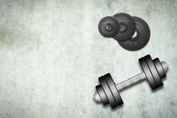 istock Dumbbells with discs of different weights, on a concrete background. Copy space. Place for text. Sports equipment, gym, fitness. Sports 1433545378