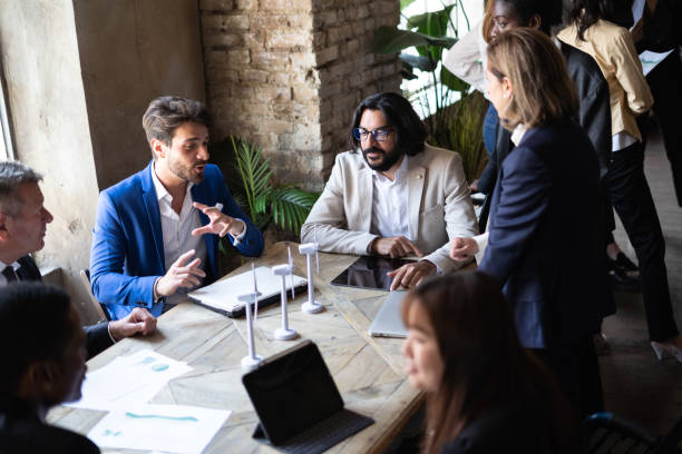 istock Multiracial business people sitting at the conference table while discussing about sustainable innovation strategy - Sustainability and green economy concept 1433548085