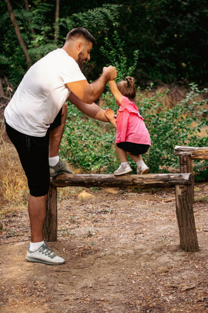 istock Father helping his little daughter overcome obstacles 1433548104