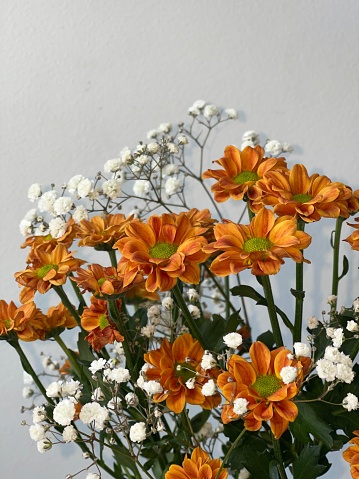 A bouquet of white and orange flowers