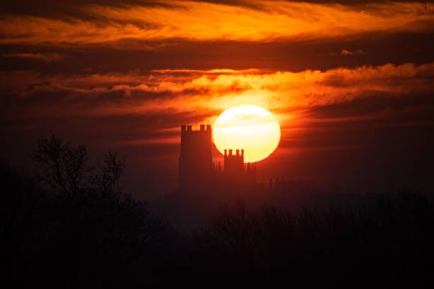 Silhouette of the Ely Cathedral against a red cloudy sky during the sunset The silhouette of the Ely Cathedral against a red cloudy sky during the sunset ely england stock pictures, royalty-free photos & images