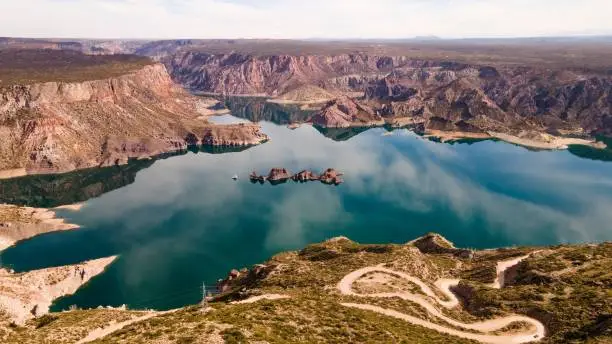 An aerial view of Atuel Canyon with cloudy sky reflection on the water, San Rafael, Mendoza, Argentina