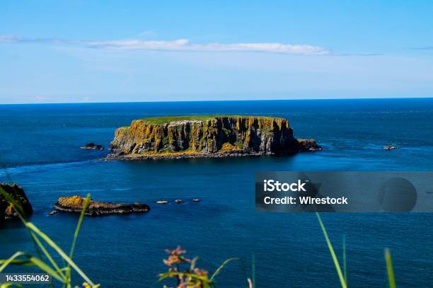 Scenic View Of An Island On The Bay Of The Cow On The Causeway Coast Bushmills Northern Ireland Stock Photo - Download Image Now