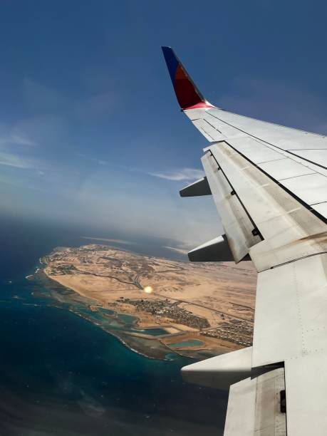 istock Airplane wing over a beautiful beach 1433554498