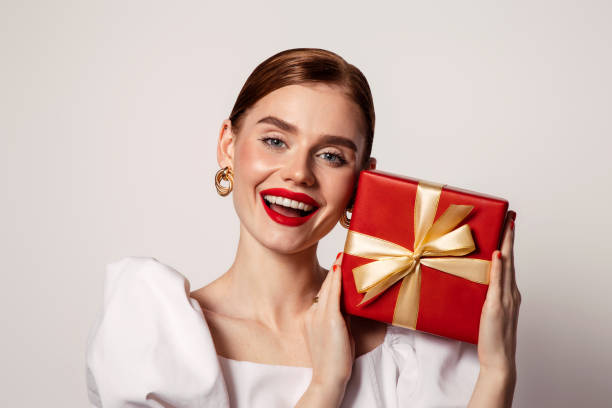 istock Beautiful emotional woman holding present box 1433556182