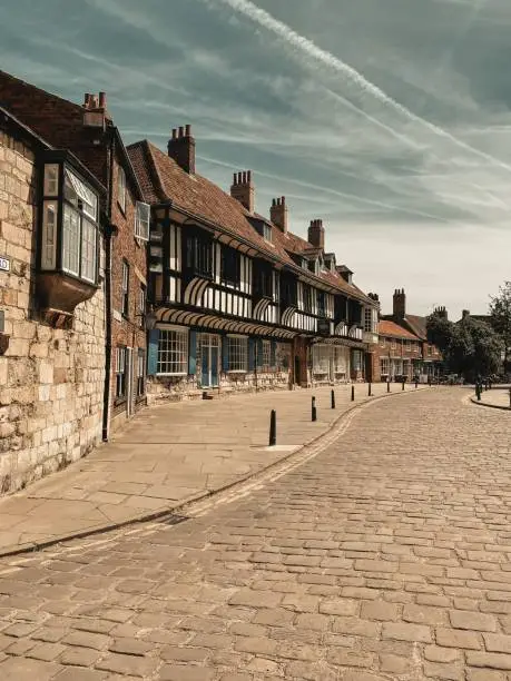 Photo of View of college street in York. The Tudor style buildings is the St Williams College