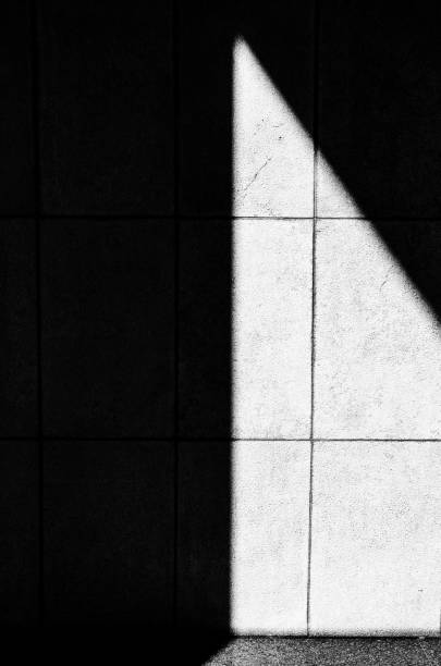 istock Grayscale vertical shot of shadow and sunlight on the wall 1433558951