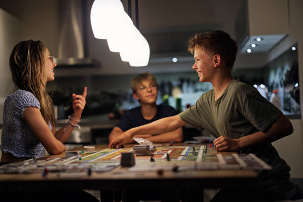 istock Teenagers playing large board game together at home 1433558970