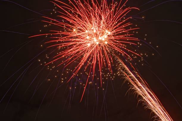 istock Night sky with red glowing fireworks - concept of holidays and celebration 1433559967