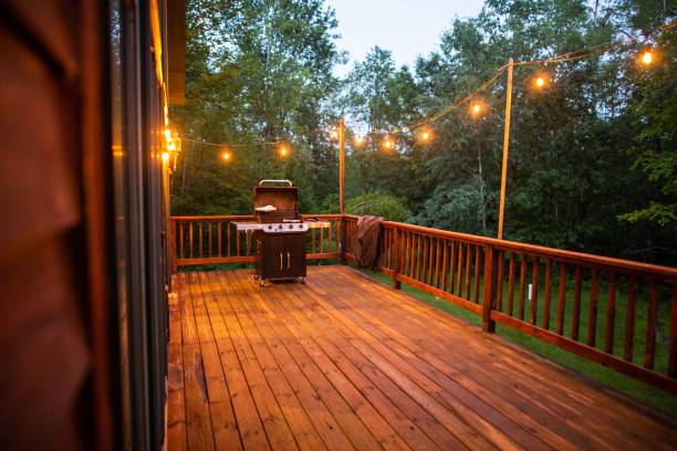 istock Wooden porch with string lights and grill 1433561318