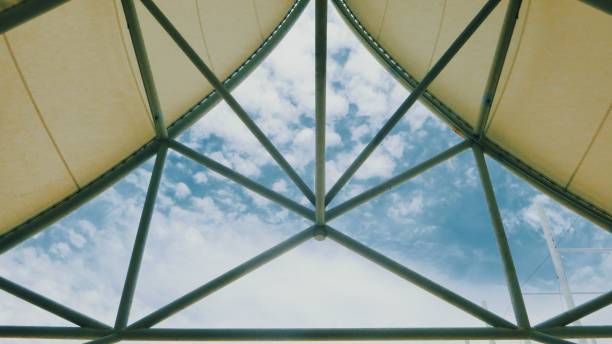 istock Pyramid with insulating glass as a ceiling against a blue sky with clouds 1433566101
