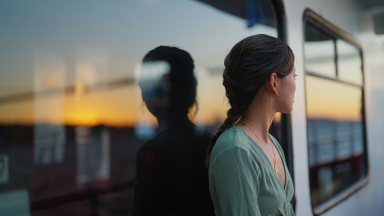 A portrait of a young female tourist traveling on a ferry.