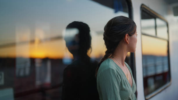 Portrait of young female tourist traveling on ferry stock photo