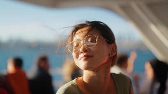 A portrait of a young female tourist traveling on a ferry.