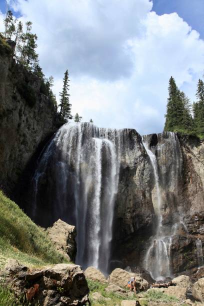 istock Vertical shot of a waterfall in a forest under the big white clouds 1433570869