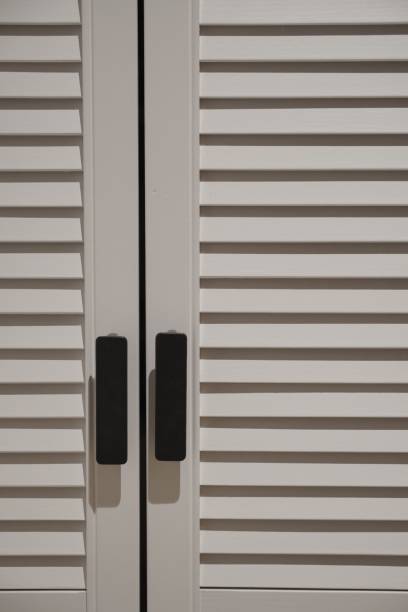 istock Vertical closeup of a louvered white window 1433570958