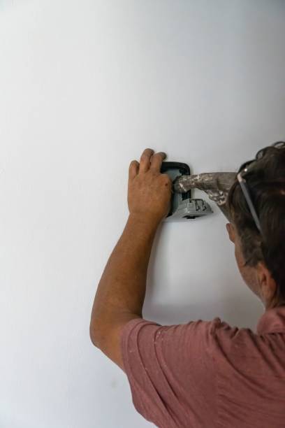 istock Mexican man installing password protected box that stores door access keys 1433572160