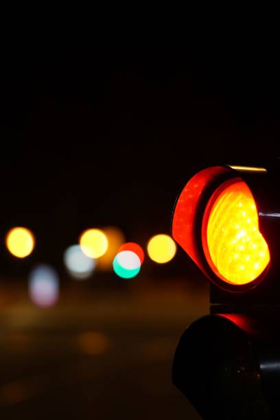 istock Orange traffic light against a bokeh background at night 1433574128