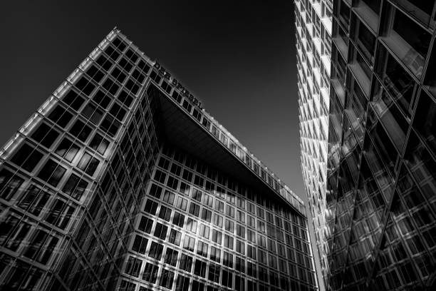 istock Low angle greyscale shot of modern buildings with beautiful architecture 1433574437