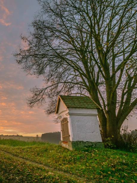 istock Aerial view of chapel surrounded by greenery fields during sunset 1433576074