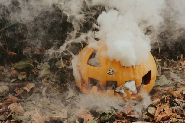 istock Scary jack-o-lantern with smoke inside in the garden 1433576563