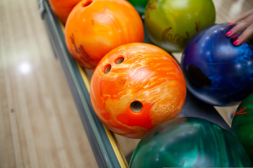 Bowling balls close-up. Paths with balls and pins for bowling. A fun game for the company.
