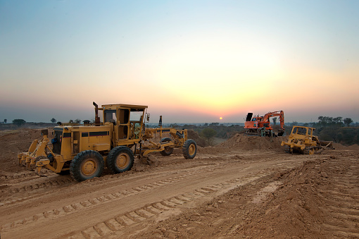 A motor grader, excavator and bulldozer on work