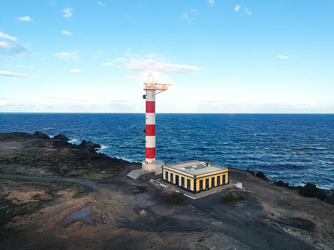 Beautiful aerial view of an illuminated lighthouse on the coast. Abona Lighthouse, Tenerife. High quality photo