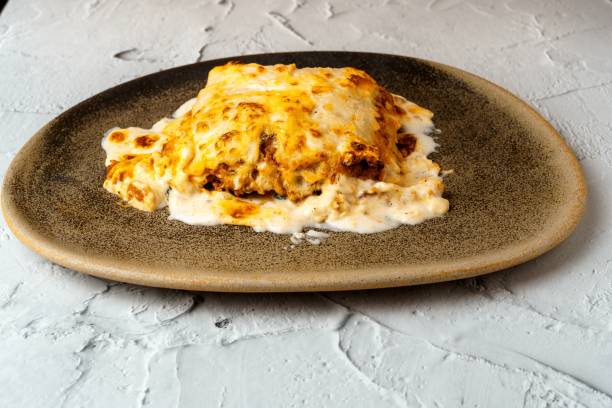 istock Meat lasagna with melted cheese served in a brown earthenware dish. Typical Italian and Mediterranean food 1433583519