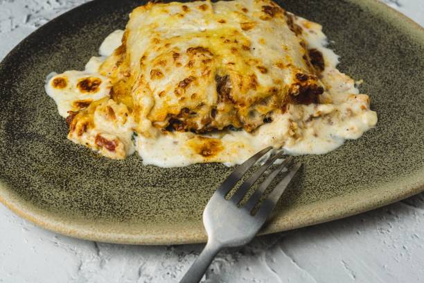 istock Meat lasagna with melted cheese served in a brown earthenware dish. Typical Italian and Mediterranean food 1433583799