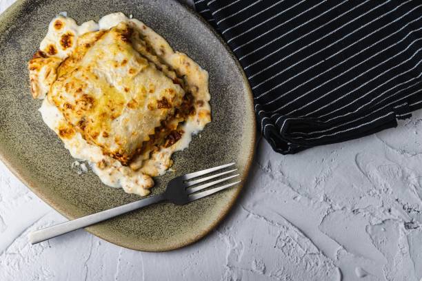 istock Meat lasagna with melted cheese served in a brown earthenware dish. Typical Italian and Mediterranean food 1433583815