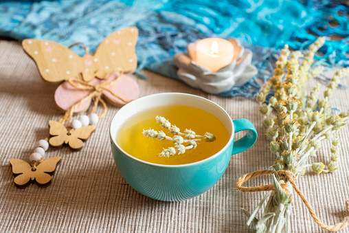 Tea in a turquoise cup with decoration - Greek mountain tea, herbal tea, white tea