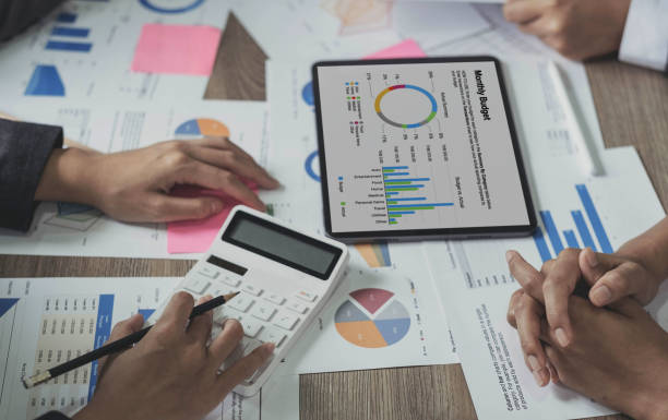 istock Business bookkeeper working with a calculator to calculate business data summary report, accountancy document and laptop computer at the office, business meeting concept. 1433584060