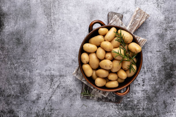 istock Raw small potatoes in a cast iron skillet on a beton background. 1433585718