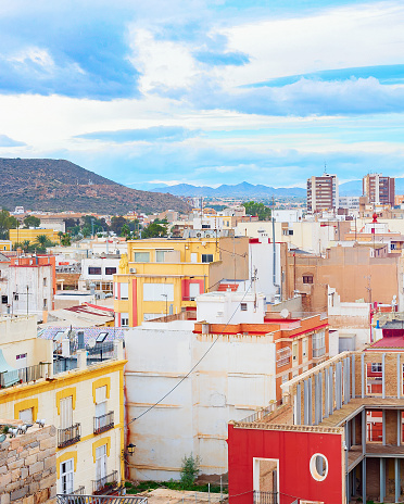 Cityscape of Cartagena, colorful houses  and mountains in backround, Spain