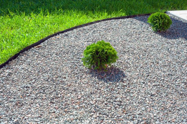 istock mulching flower beds with marble stone. Stone chips for landscaping. 1433591881