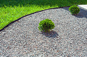 mulching flower beds with marble stone. Stone chips for landscaping.