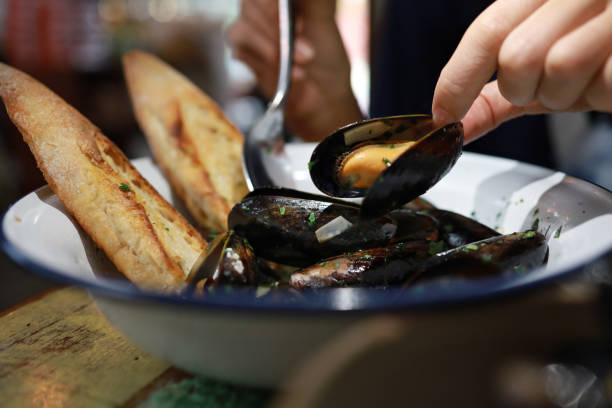 istock Mussels cooked with white wine sauce and breads in a bowl 1433594245