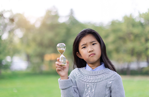 Little Girl Holding Hourglass