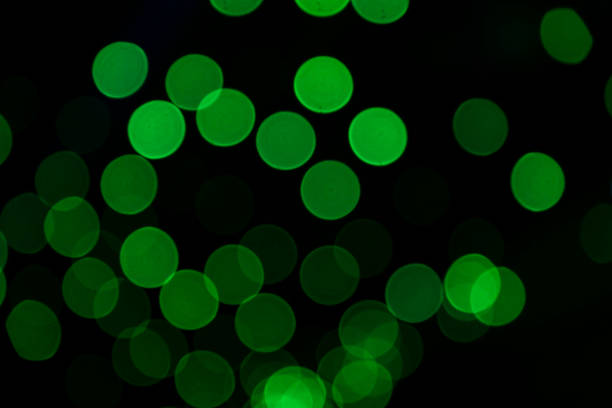 Green Defocus Abstract bokeh light effects on the night black background texture