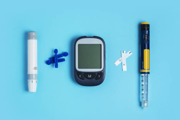 istock Measuring blood sugar. Glucometer, insulin pen, lancet and test strip on a blue background. 1433601916