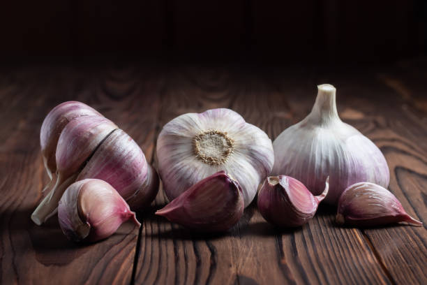 istock Garlic bulb on wooden background. Close up 1433602295