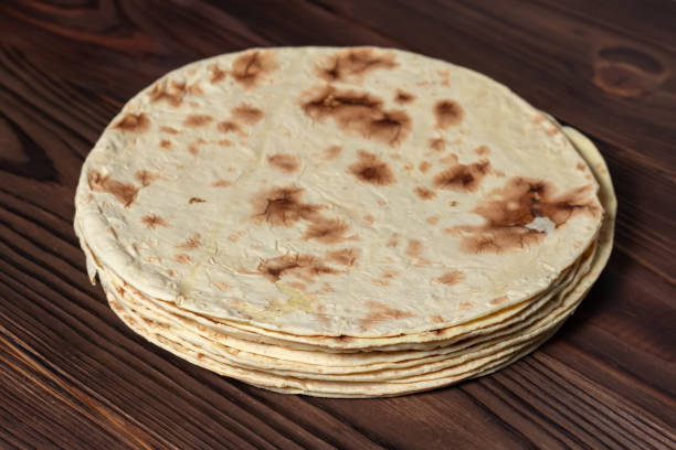 istock Taco flatbread lavash isolated on wooden background 1433604717
