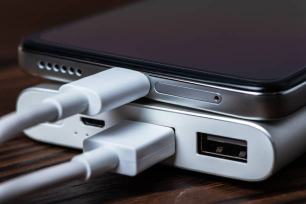 istock Smartphone charging with power bank on wood board 1433605350