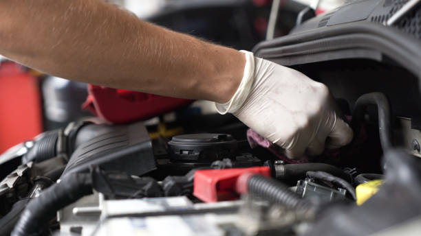istock auto mechanic repairs car engine. car service. close-up. 1433606137