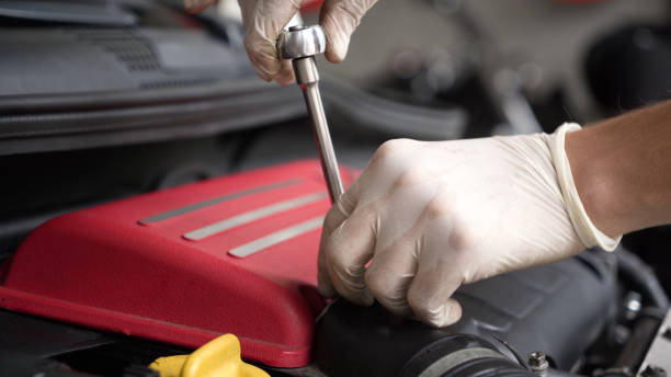 istock auto mechanic repairs car engine. car service. close-up. 1433606147