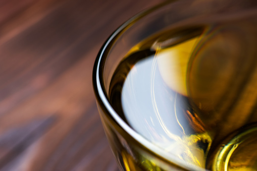 Sunflower oil in glass bowl on wooden boards