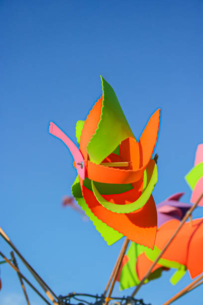 istock Colorful paper pinwheel craft under blue sky 1433608295